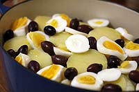 Finish with a layer of potatoes, sliced hard boiled egg, and olives bacalhoada-6.jpg