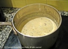 Pot of clam chowder on stove / New England Clam Chowder recipe - www.boston-discovery-guide.com
